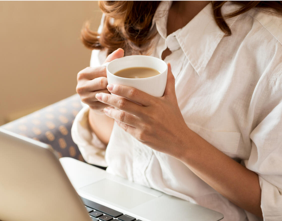 A calm online therapy setting with laptop and coffee